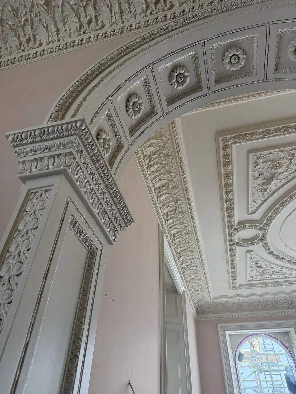 Completed fibrous plaster arch with rosette coffers and acanthus frieze