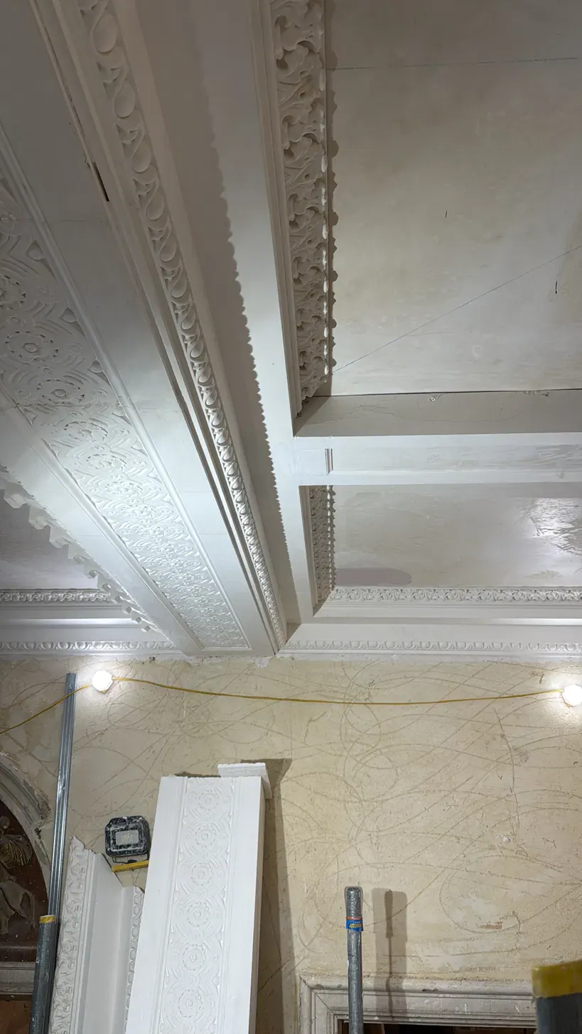 Newly cast fibrous plaster cornice run ready to be fixed in place