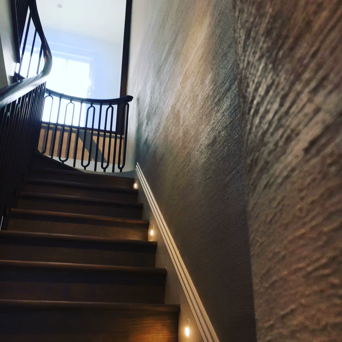 Textured metallic polished plaster to a staircase wall, London