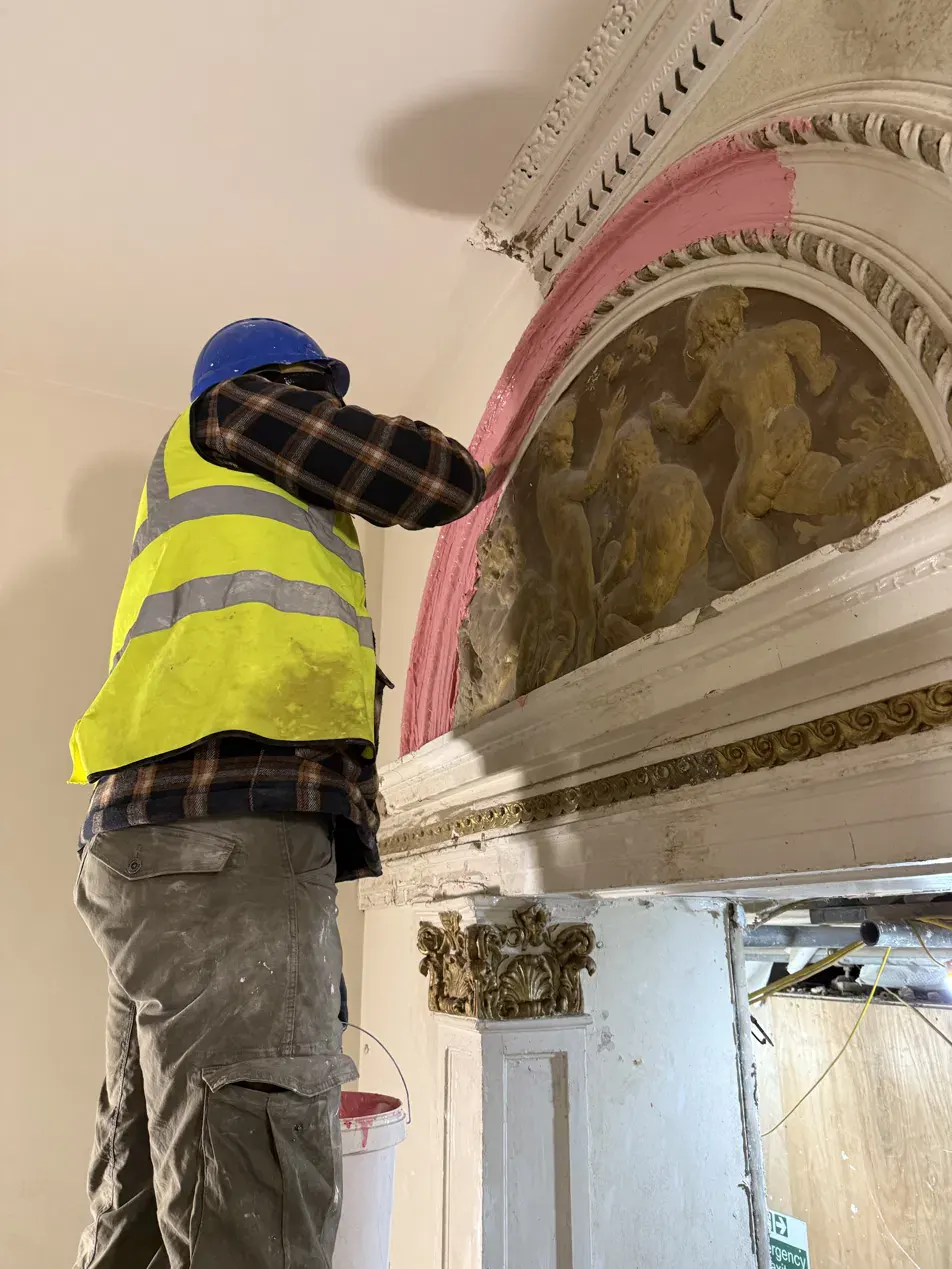 A mould being taken from an original figurative plaster relief